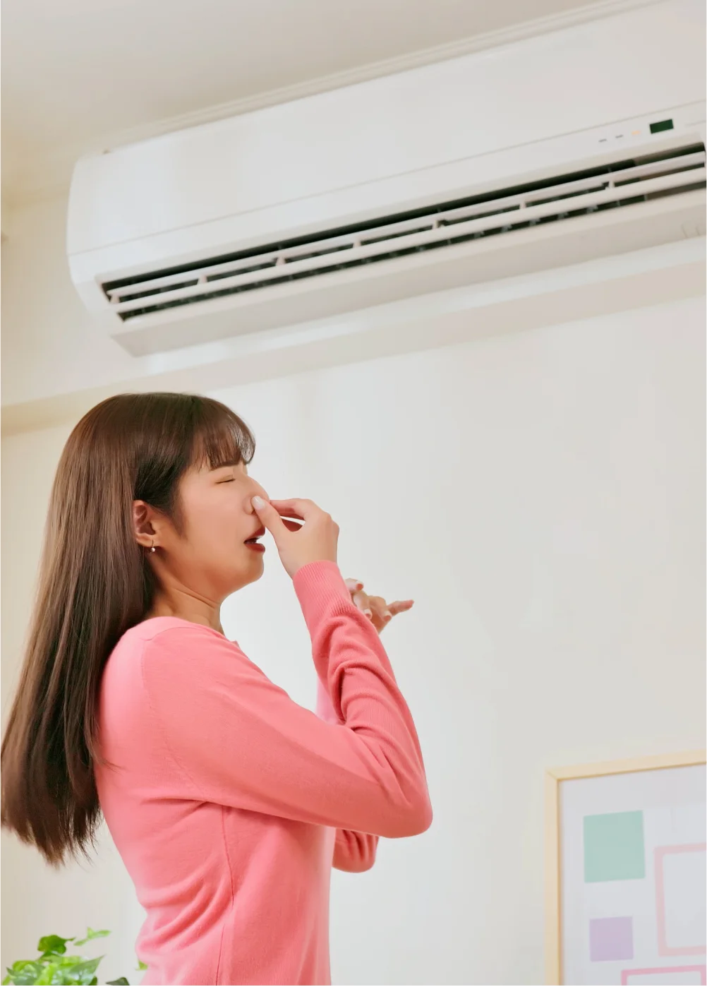 Woman holding her nose because of a bad smell