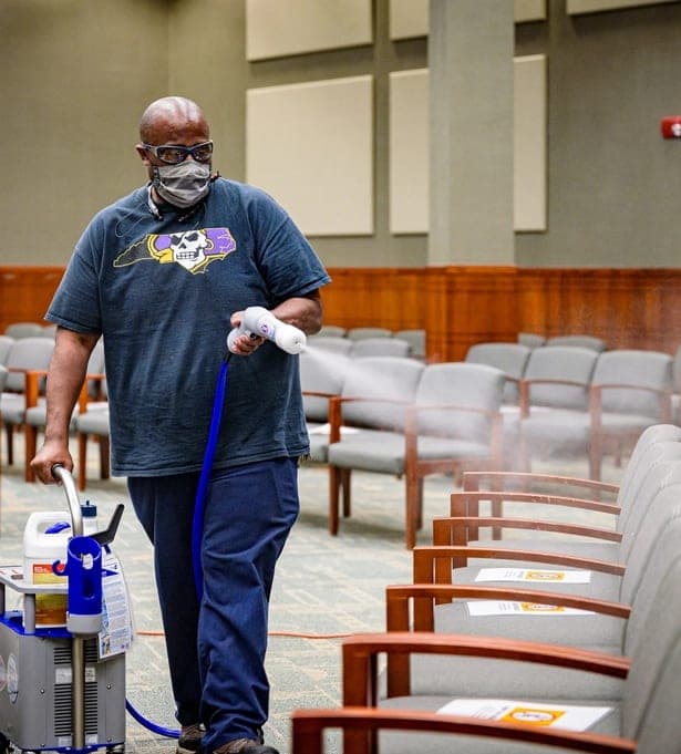 Technician sanitizing a commercial space