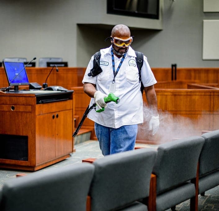 Technician treating a room to eliminate odors